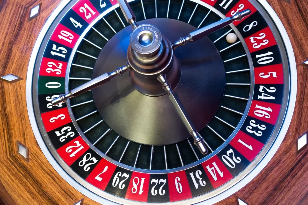 A high-quality close-up of a classic wooden roulette wheel with a white ball landing on a winning number, representing safe and licensed EU online gambling in 2026.