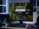 A computer monitor displaying a Minecraft guide titled 'The Ultimate Minecraft Axolotl Hunting Guide' on a gaming desk setup with an RGB keyboard and mouse.